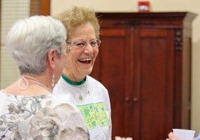 Providence Associate Donna Watzke laughs while visiting with sisters and associates at the retreat.