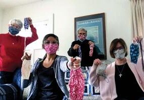 Sisters living in the formation house, from left, Sisters Marsha Speth, Jessica Vitente, Nancy Bartasavich and Janice Smith, show off the masks they have made. 