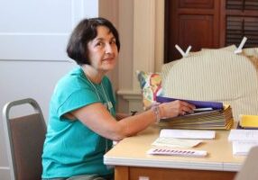 Providence Associate Monica Hayden volunteers stuffing folders Friday morning.